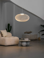 Latticed pendant light shown lit in a styled room