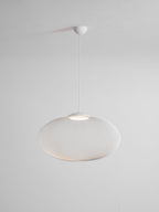 Mesh pendant light glowing warm above a seating area