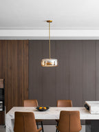 Smoked glass dome pendant light glowing over a kitchen island