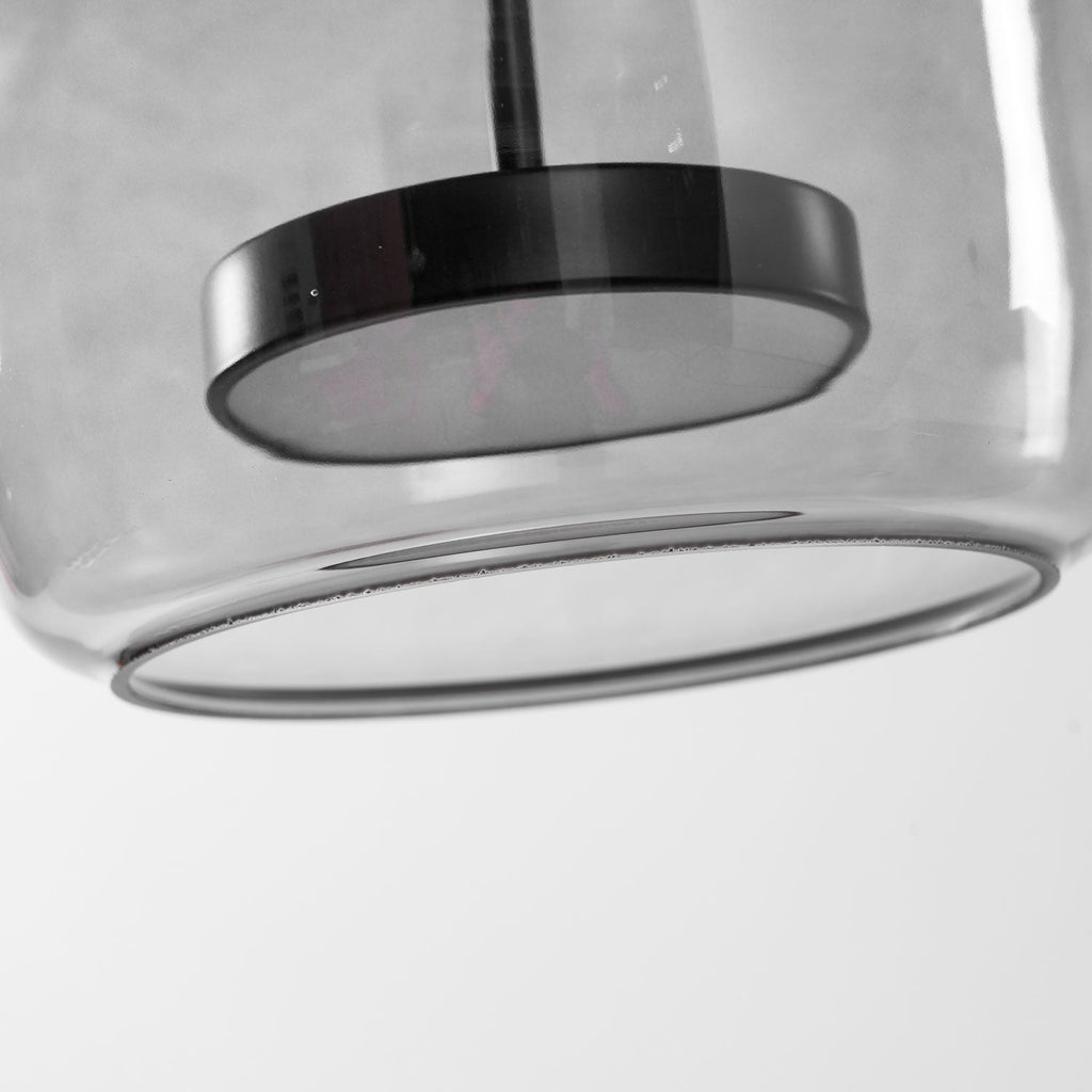Glass globe pendant light with warm LED in a cozy interior