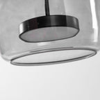 Glass globe pendant light with warm LED in a cozy interior