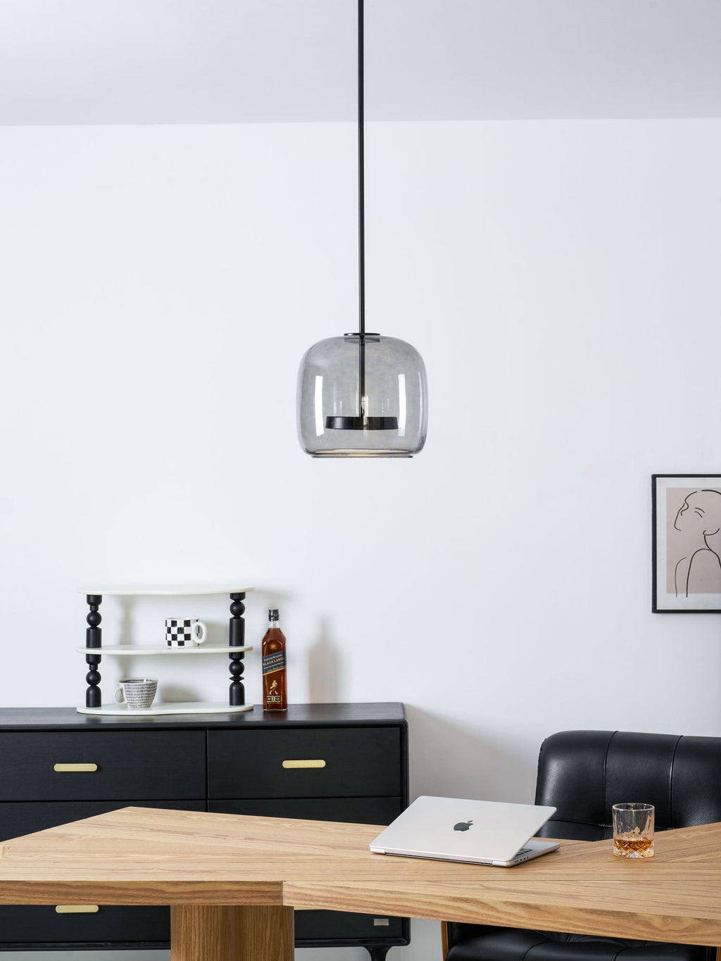 Glass globe pendant light glowing in a styled room setting