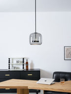 Glass globe pendant light glowing in a styled room setting