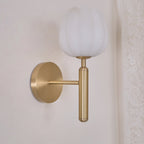 Close crop of the brass Eurzorion sconce beside a lace curtain, showing the arm's clean right angle