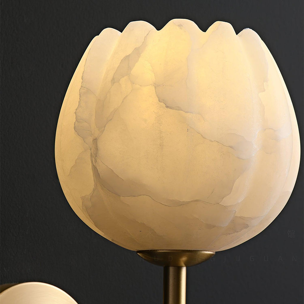 Close-up of the lit alabaster shade, showing its scalloped petal rim and natural stone veining