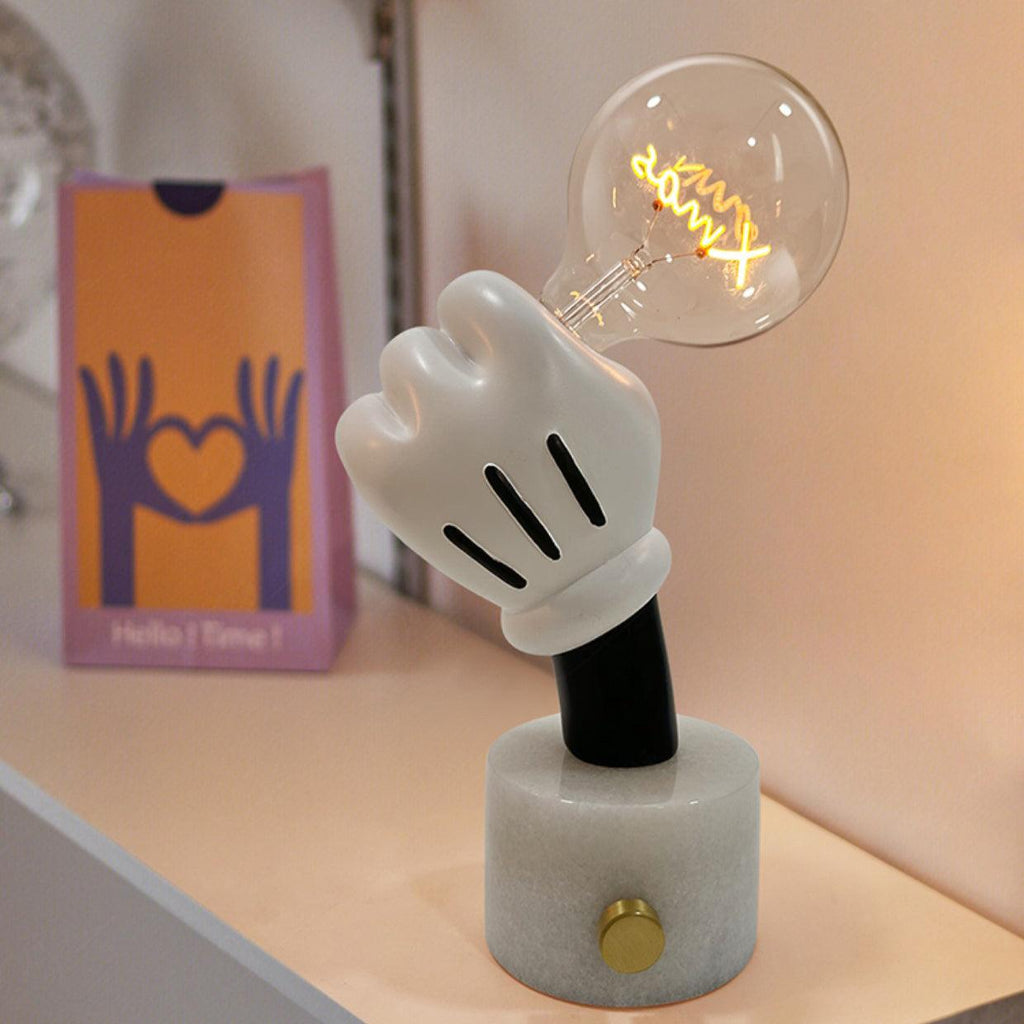 Clérachic novelty table lamp on a white marble base beside an orange gift box printed with a heart-shaped hand graphic.