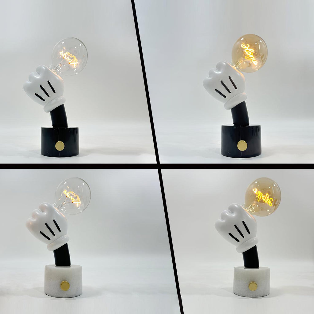 Four Clérachic novelty table lamps shown together, comparing black and white marble bases with clear and cognac bulbs.