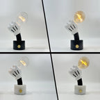 Four Clérachic novelty table lamps shown together, comparing black and white marble bases with clear and cognac bulbs.