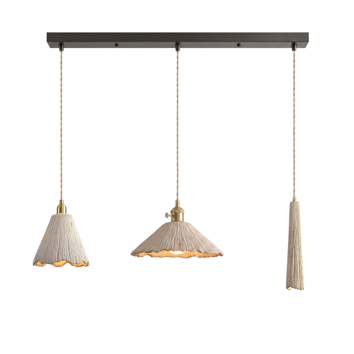 Three microcement pendants on a dark linear ceiling canopy: a tall scalloped cone, a wide scalloped cone and a slim tapered shade, each on a braided cord