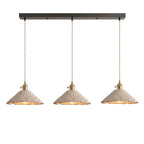 Three wide scalloped cone microcement pendants hung in a row from a dark linear ceiling canopy on braided cords