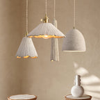 Microcement pendant light hanging against a neutral wall