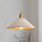 Microcement pendant light shown lit from a braided cord