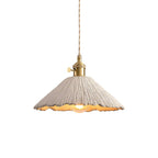 Cement pendant light glowing softly in an interior