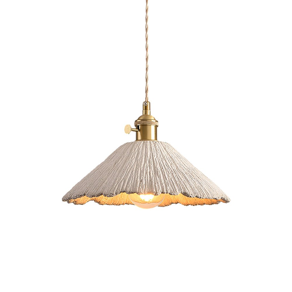 Cement pendant light glowing softly in an interior