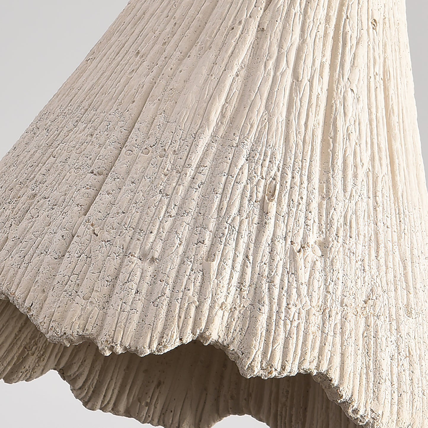 Microcement pendant light glowing softly in a styled room