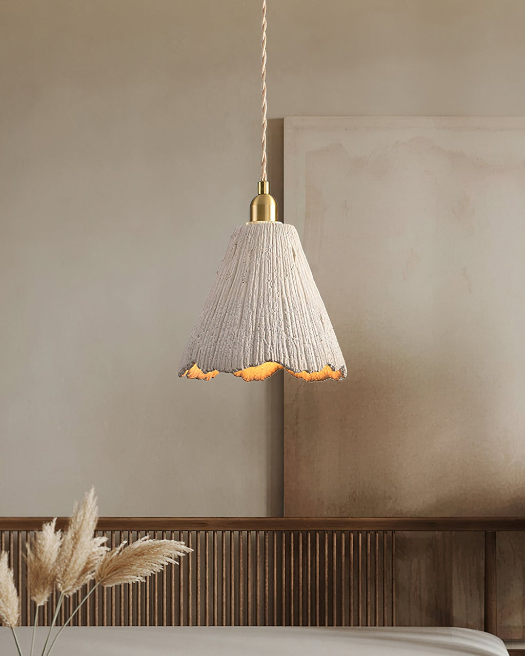 Raw microcement pendant light with gold fitting close up