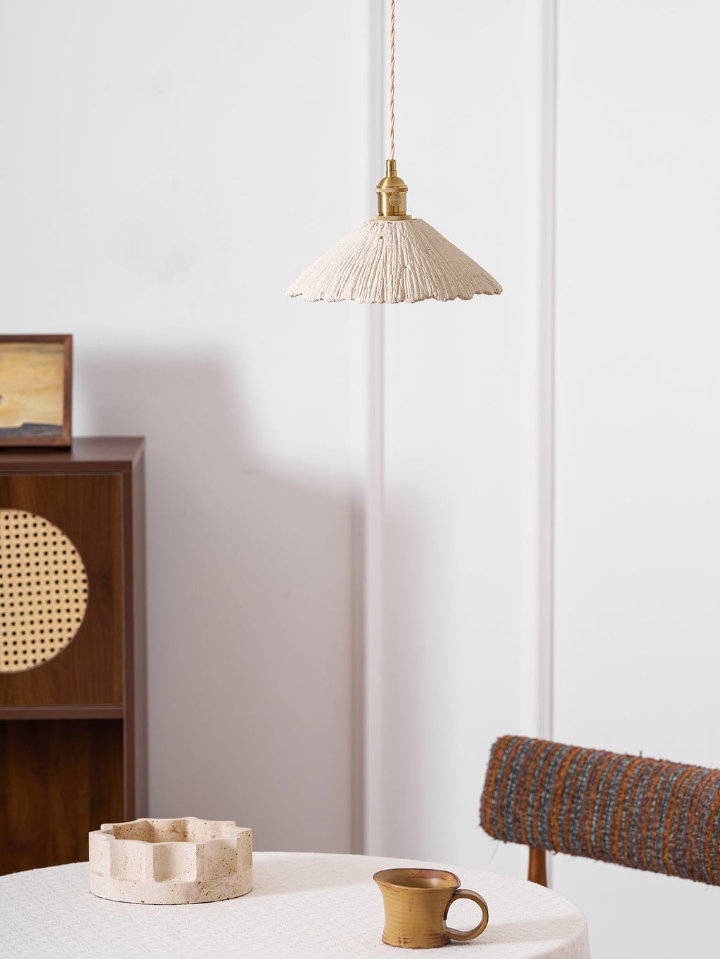 Disc shaped cement pendant light detail of the raw surface