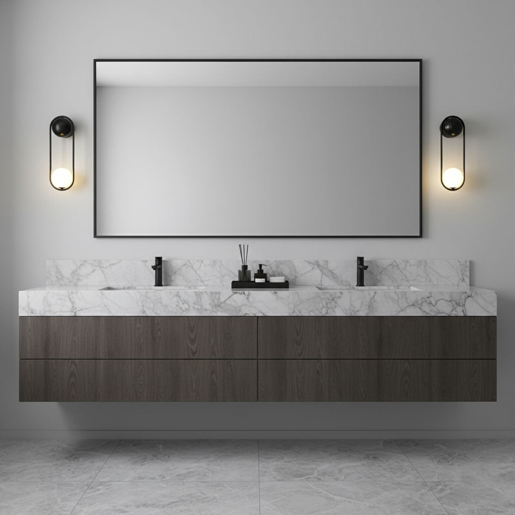 Black-finish Clérachic wall lights flank a rectangular mirror above a marble bathroom vanity with dark wood cabinetry.