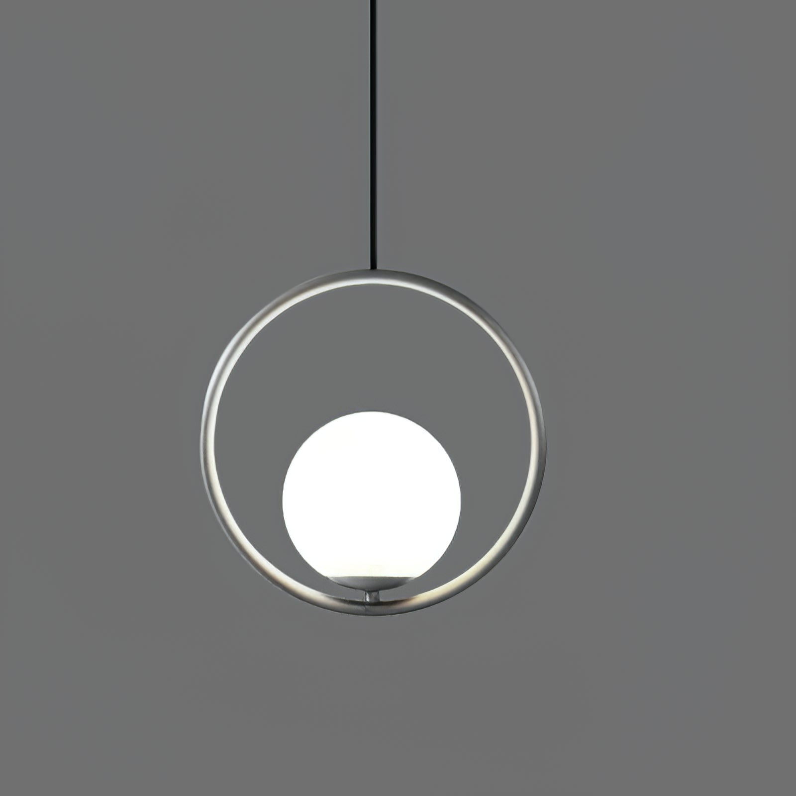 Brass and white glass pendant light suspended overhead