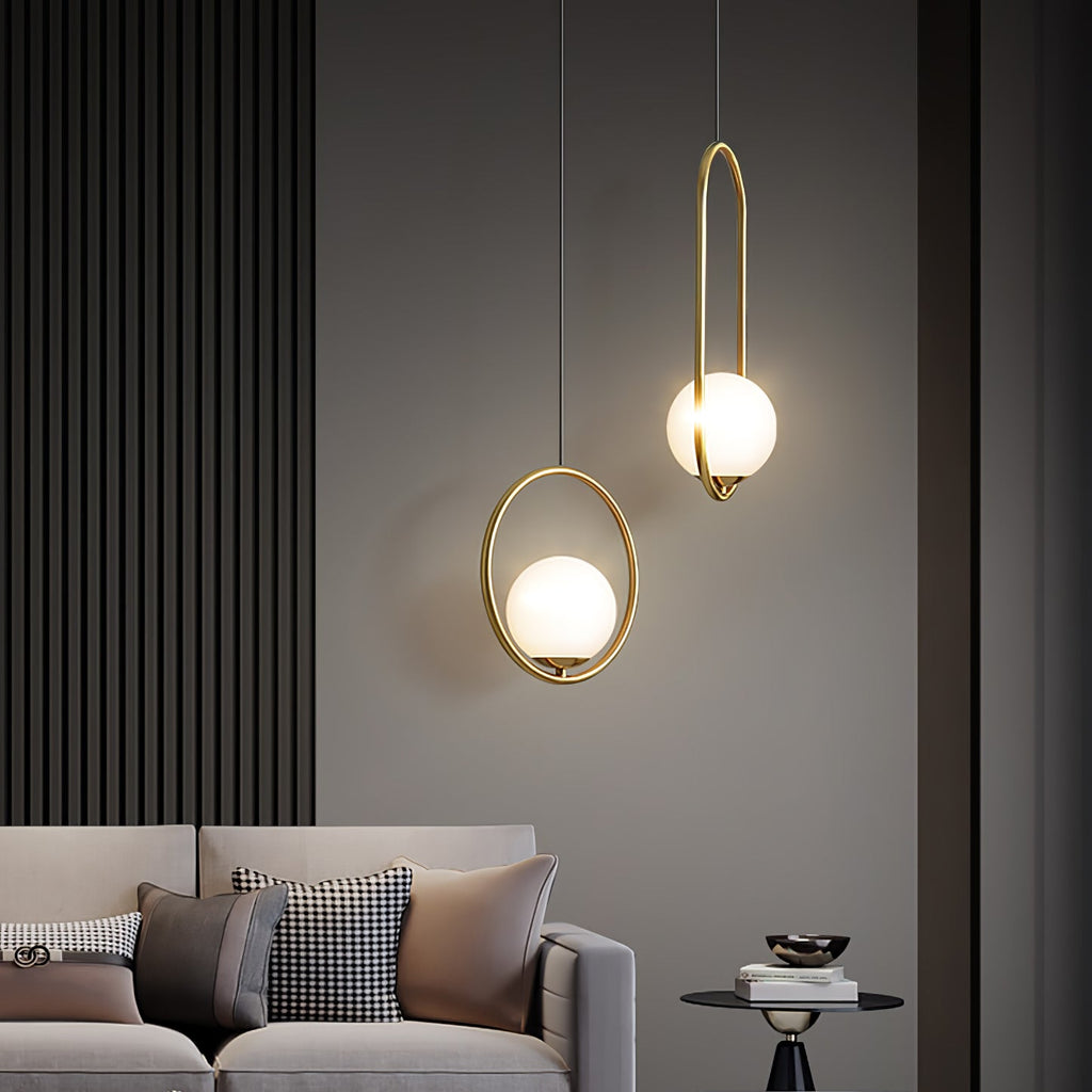 Glass ball pendant light glowing against a dark backdrop