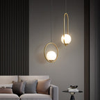 Glass ball pendant light glowing against a dark backdrop