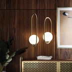 White glass globe pendant light shown above a table