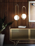 Glass ball pendant light shown lit in a dining space