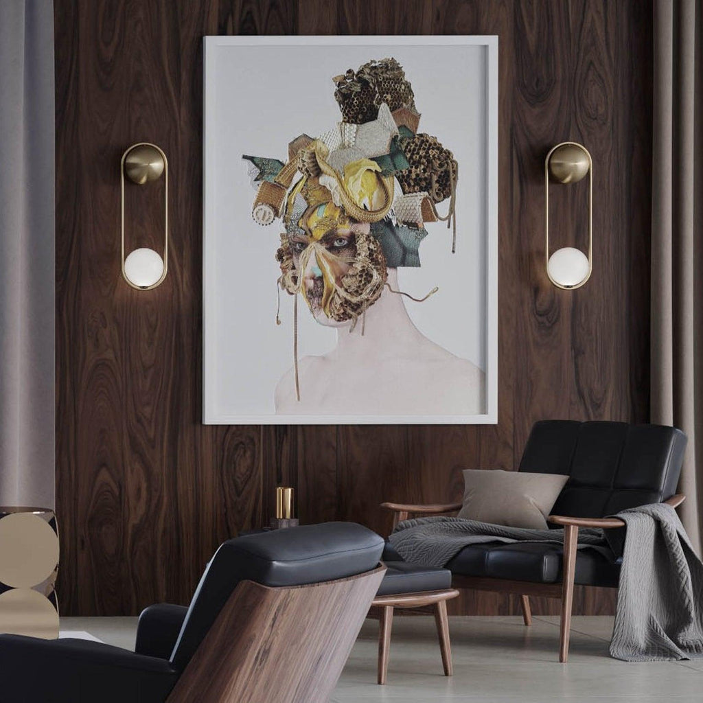 Two brass Clérachic wall lights flank a framed portrait above dark armchairs in a wood-panelled room.