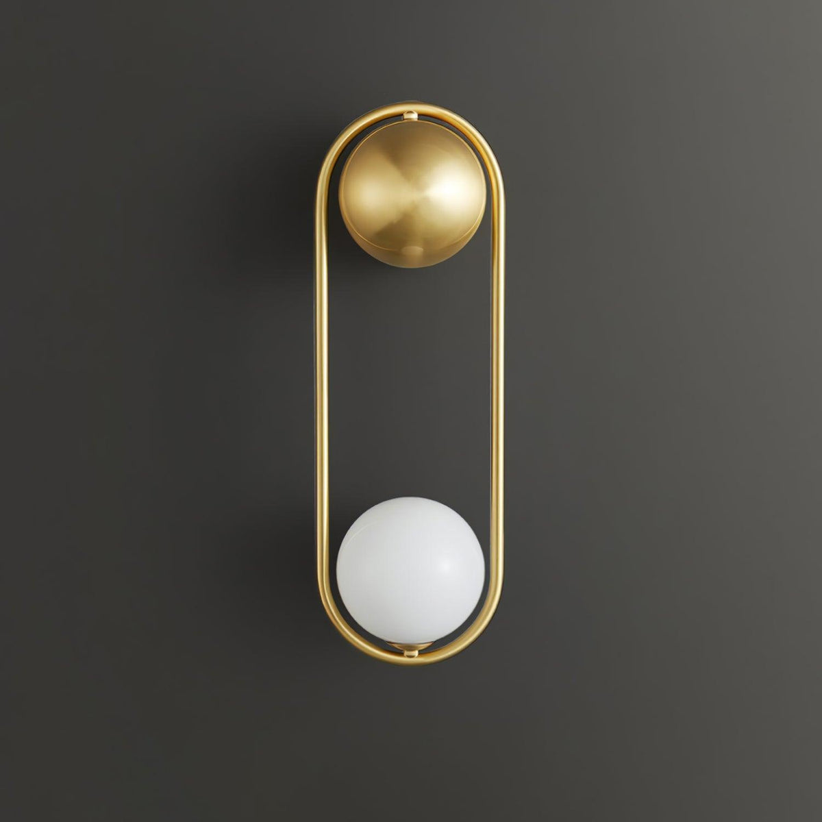 A brass Clérachic wall light on a dark charcoal background, its opal glass globe shown unlit at the base of the oval frame.