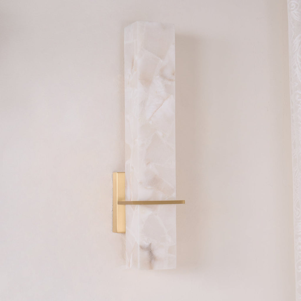 Unlit in daylight, the mosaic pattern of the alabaster shows against a cream wall and lace curtain
