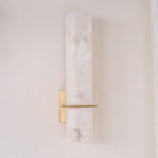 Unlit in daylight, the mosaic pattern of the alabaster shows against a cream wall and lace curtain