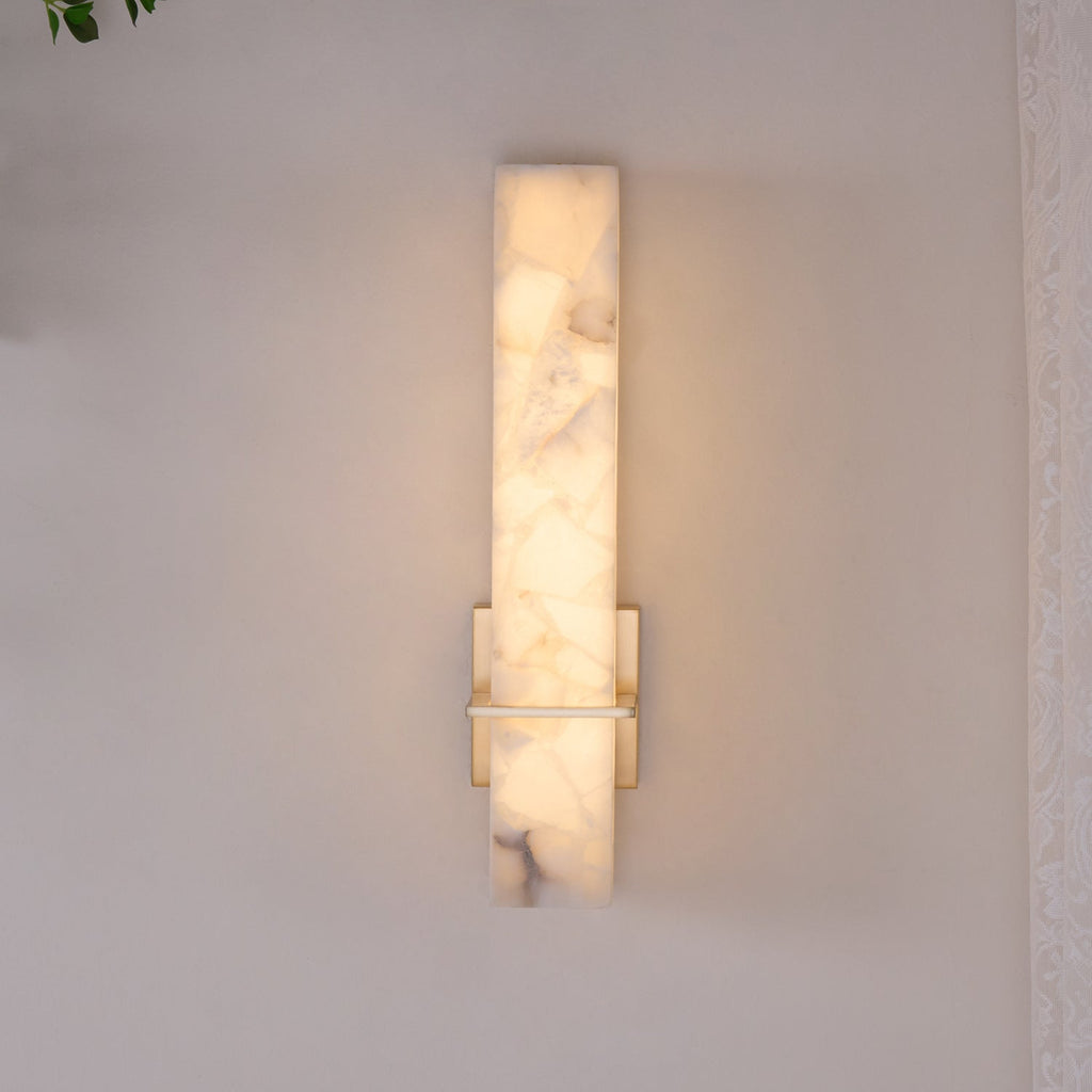 Straight-on view of the wall light switched on, warm glow through the mosaic alabaster face