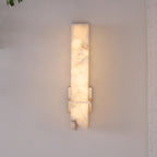 Straight-on view of the wall light switched on, warm glow through the mosaic alabaster face