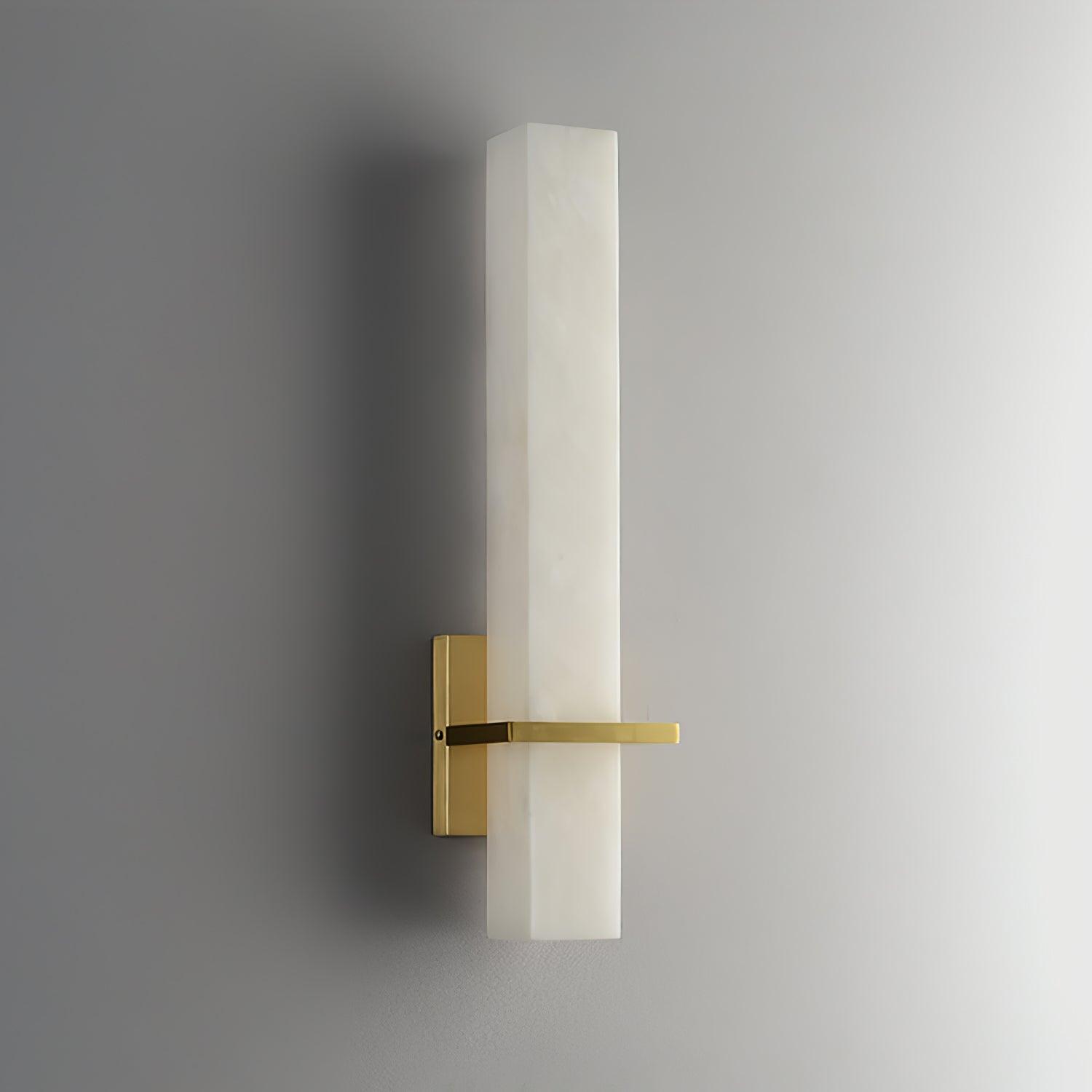 The wall light unlit, angled to show the square-cut edge of the alabaster block
