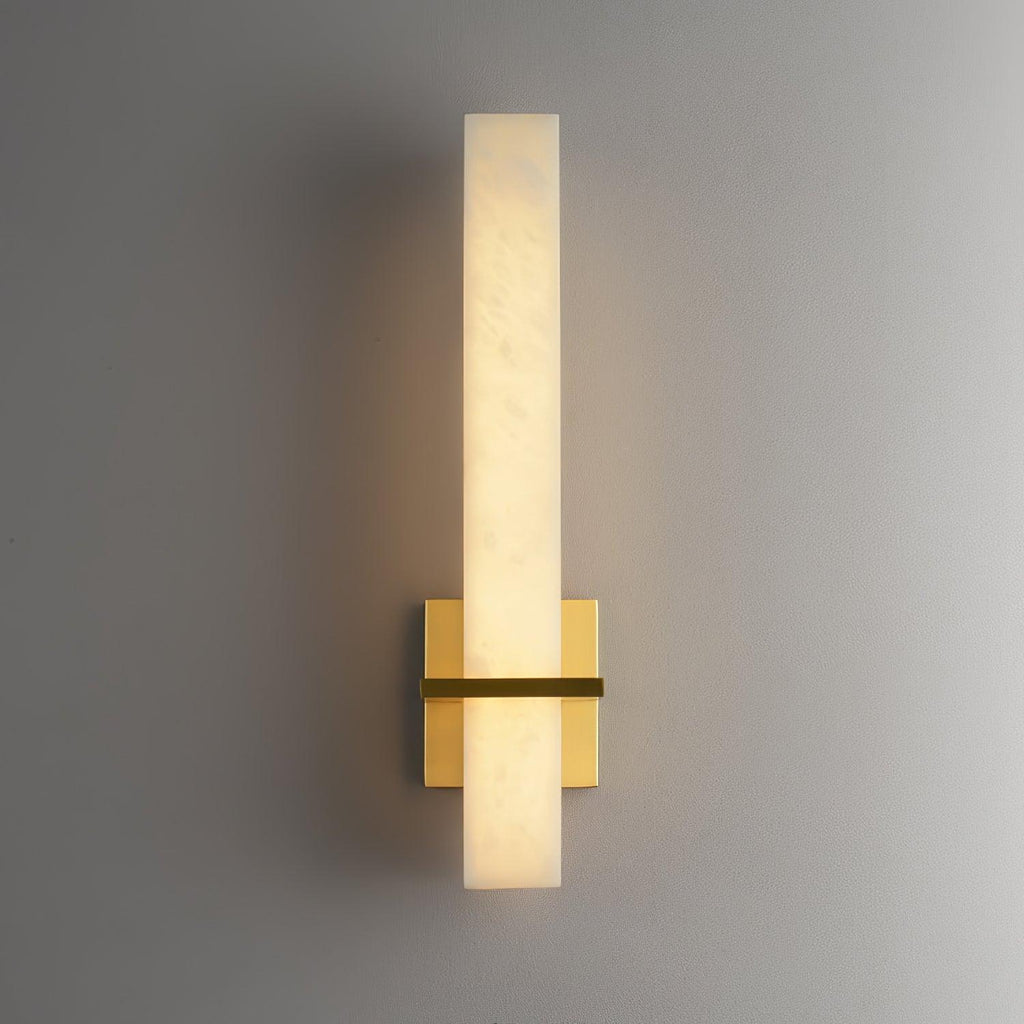 Alabaster wall light with a polished square brass backplate, lit and viewed straight on