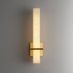 Alabaster wall light with a polished square brass backplate, lit and viewed straight on