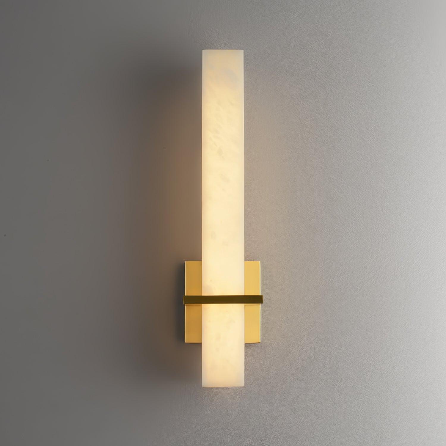 Alabaster wall light with a polished square brass backplate, lit and viewed straight on