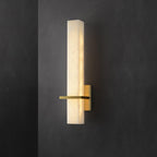 The lit alabaster block against dark plaster, polished brass bar crossing at its lower third