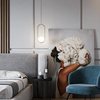 Elongated oval glass pendant light glowing softly