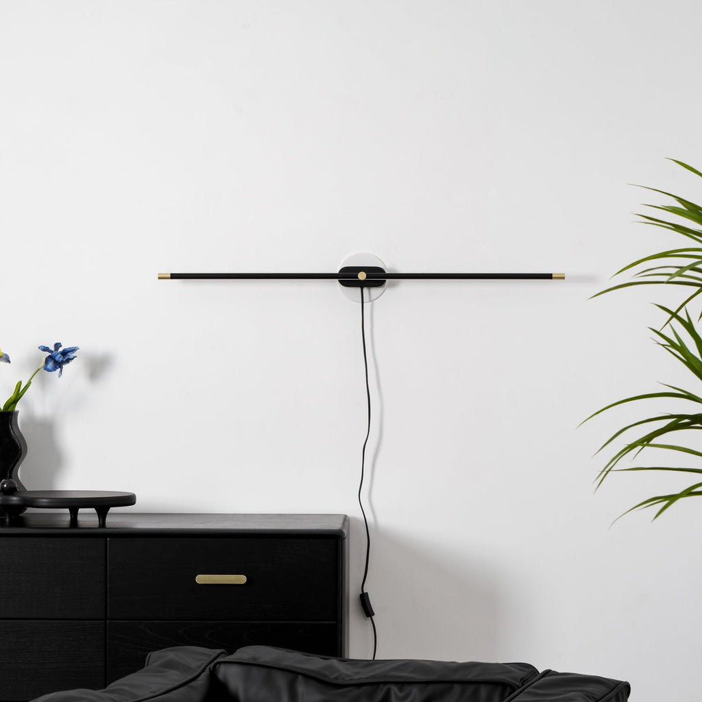 Minimalist bar lamp mounted on a bathroom wall