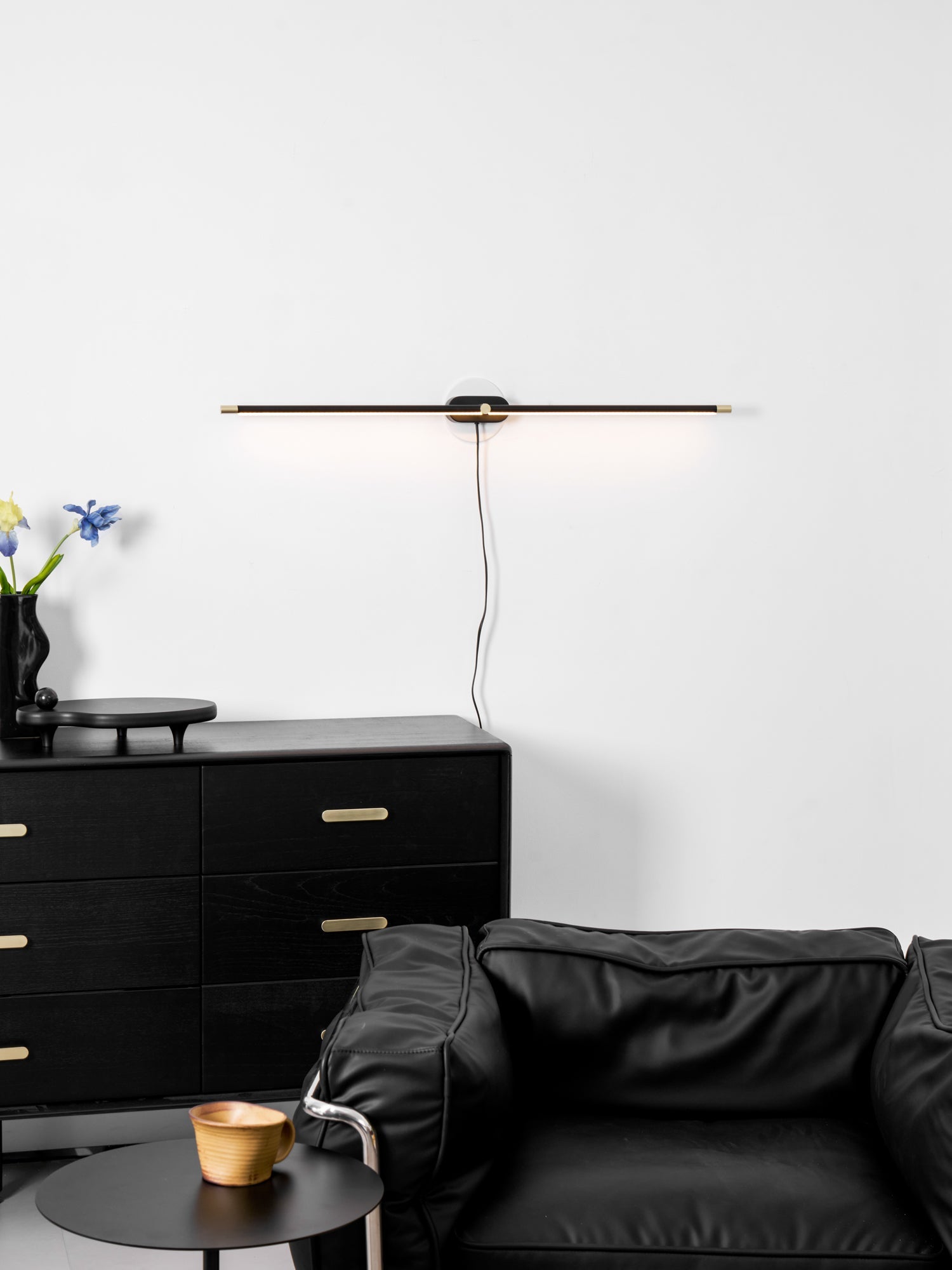 Slim wall lamp with warm light in a modern bathroom
