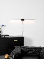 Linear LED bar lamp glowing above a wall mirror
