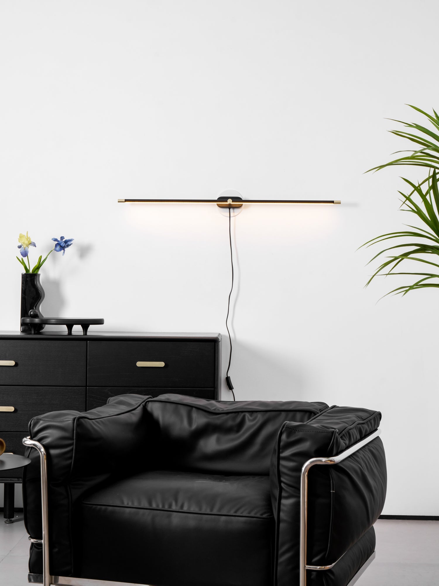 Linear LED wall lamp casting an even glow on a mirror