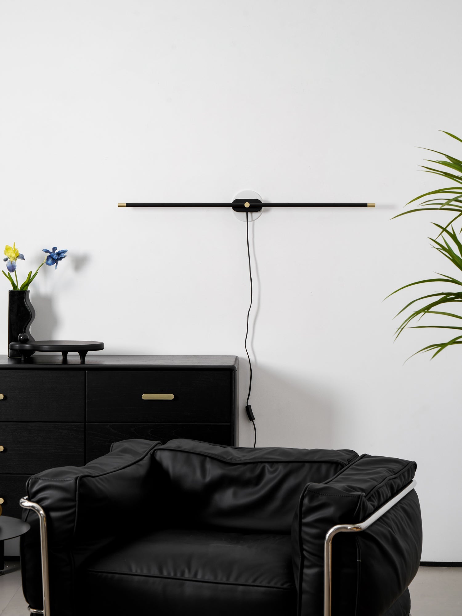 Minimalist linear wall lamp glowing in a soft-lit room