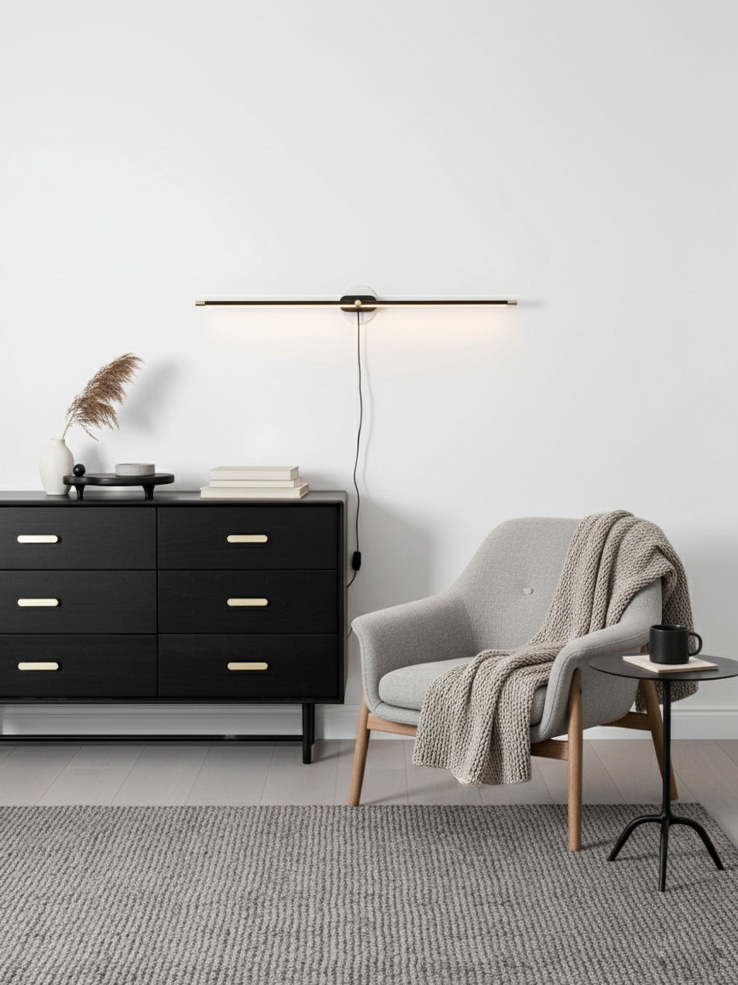 Slim LED wall lamp glowing over a framed picture