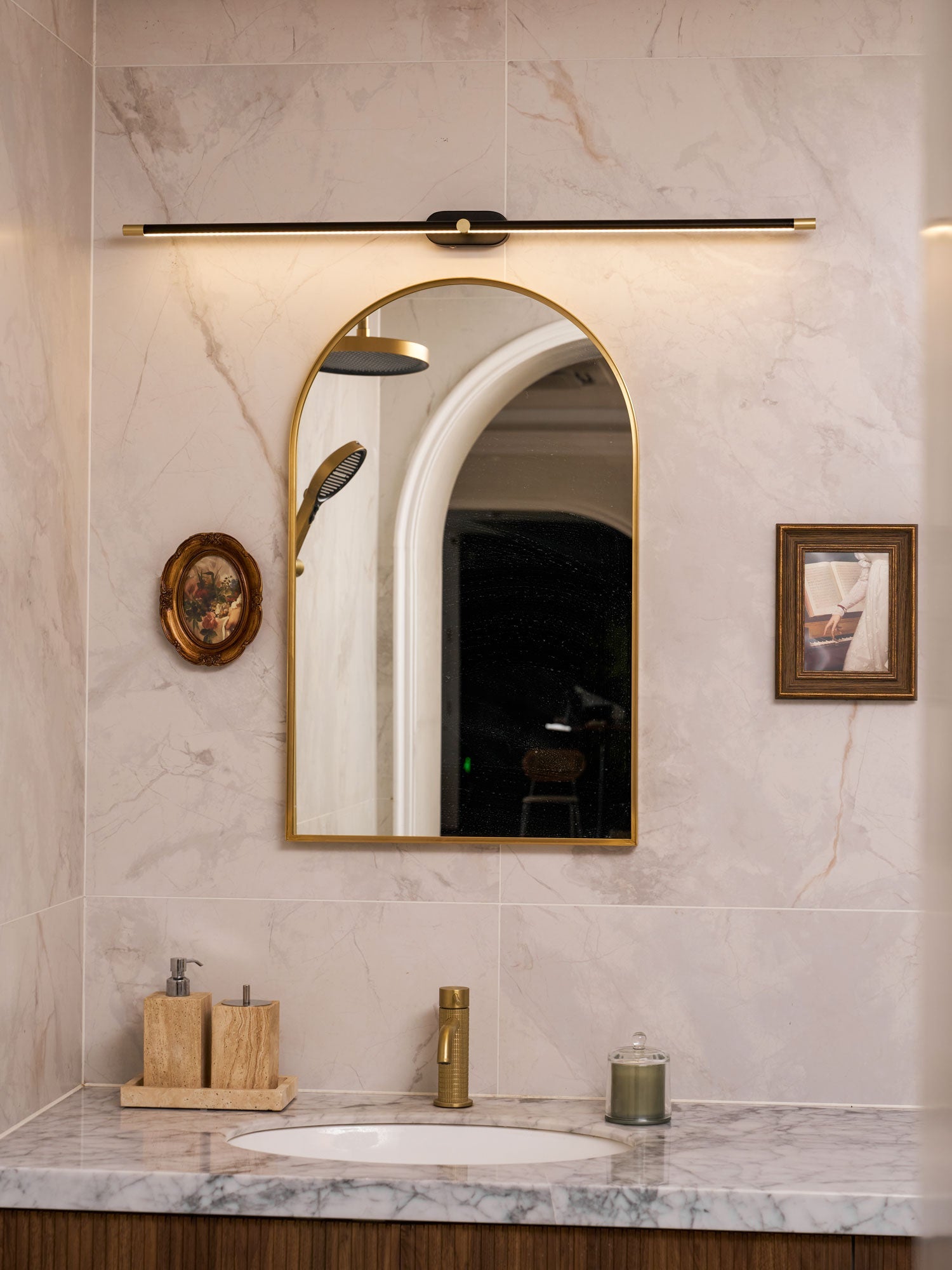 Linear LED wall lamp casting soft light over a vanity area