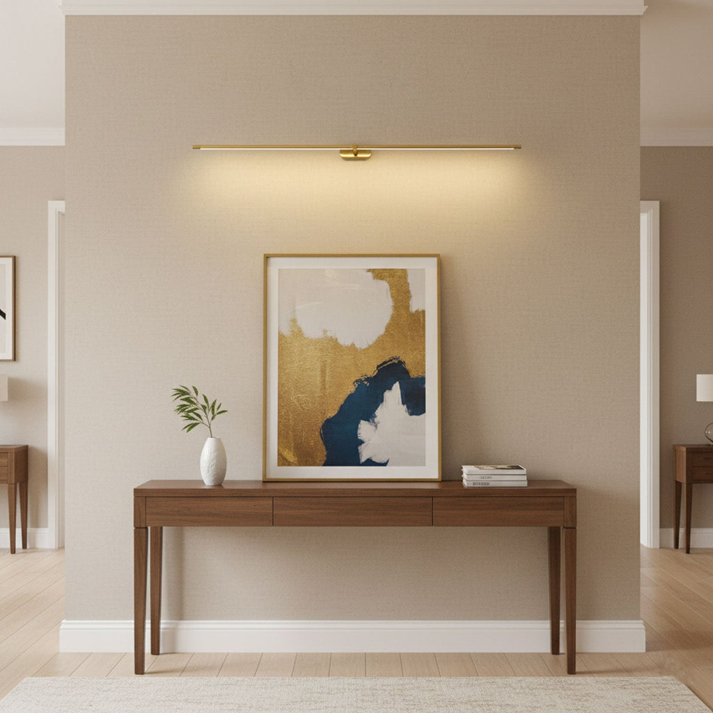 Minimalist linear wall lamp above a mirror in a bathroom
