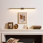 Minimalist linear wall lamp glowing beside a framed mirror