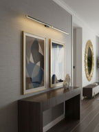 Linear wall lamp lit in a minimalist bathroom vanity setting