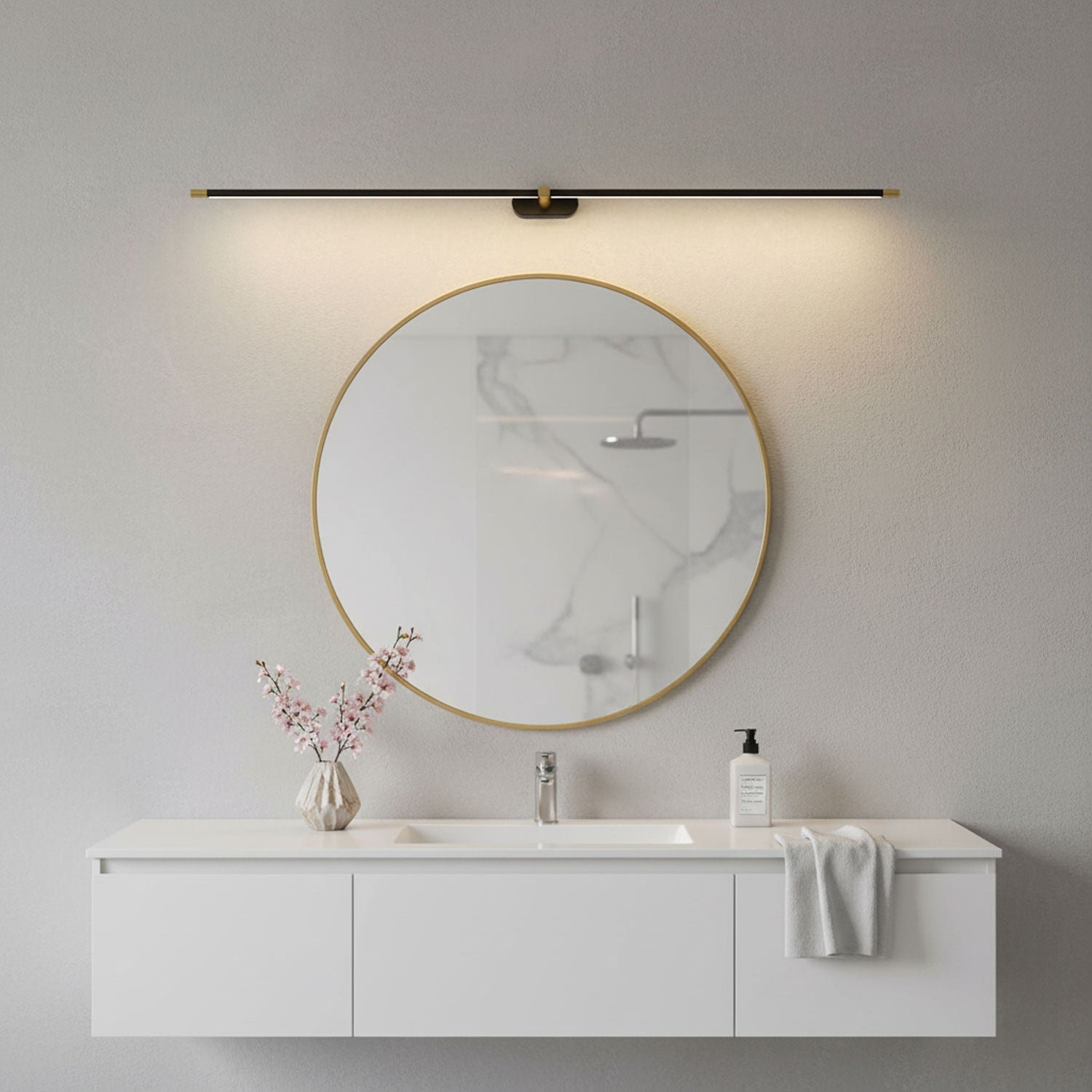 Linear wall lamp shown lighting a framed artwork on a wall